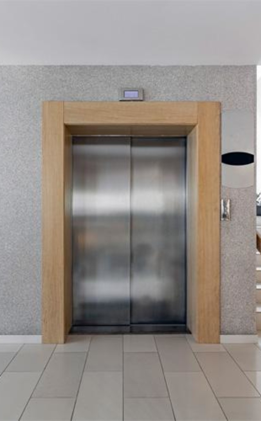 Luxury lifestyle design. Modern interior design. Modern steel elevator. Stairs. Nobody inside.